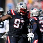 Sep 28, 2025; Foxborough, Massachusetts, USA; New England Patriots defensive end Milton Williams (97) and safety Craig Woodson (31) react after making at tackle against the Carolina Panthers during the first half at Gillette Stadium. Mandatory Credit: Brian Fluharty-Imagn Images