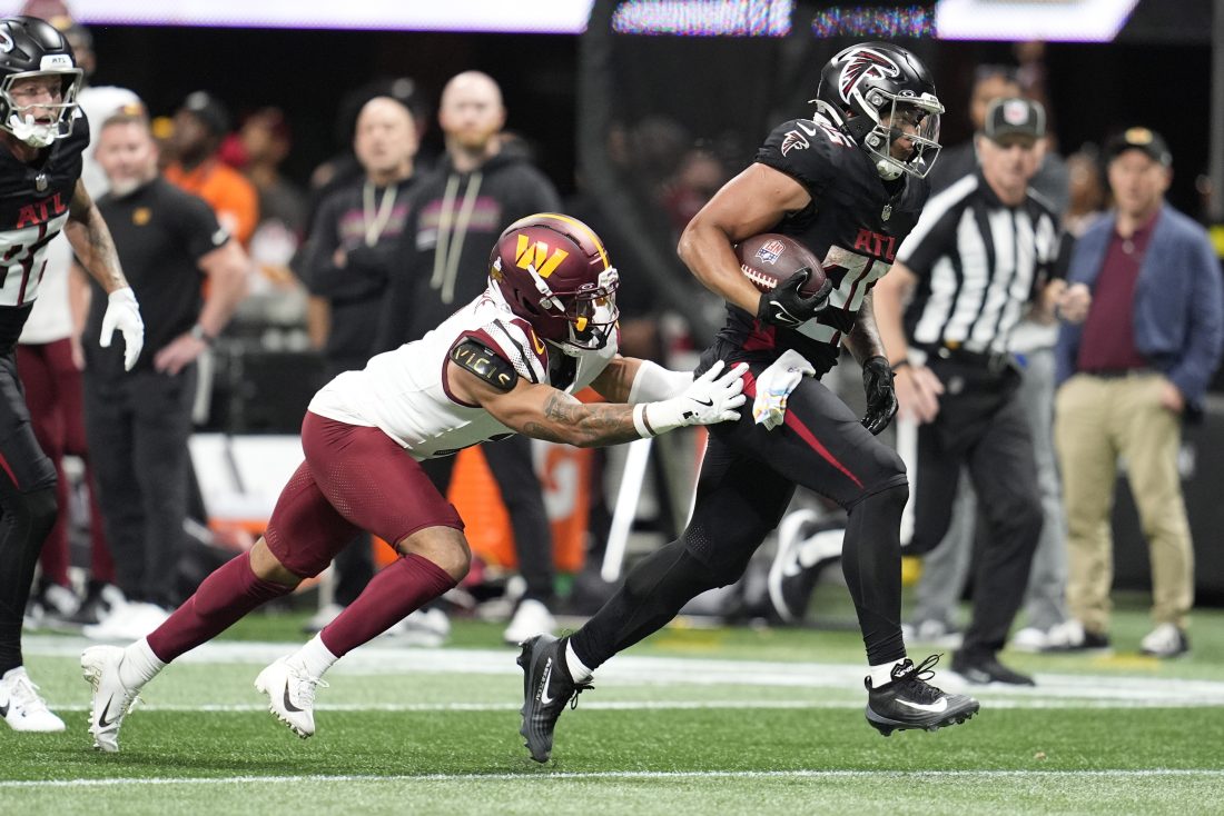 Sep 28, 2025; Atlanta, Georgia, USA; Atlanta Falcons running back Tyler Allgeier (25) breaks away from Washington Commanders cornerback Marshon Lattimore (2) during the second half at Mercedes-Benz Stadium. Mandatory Credit: Dale Zanine-Imagn Images