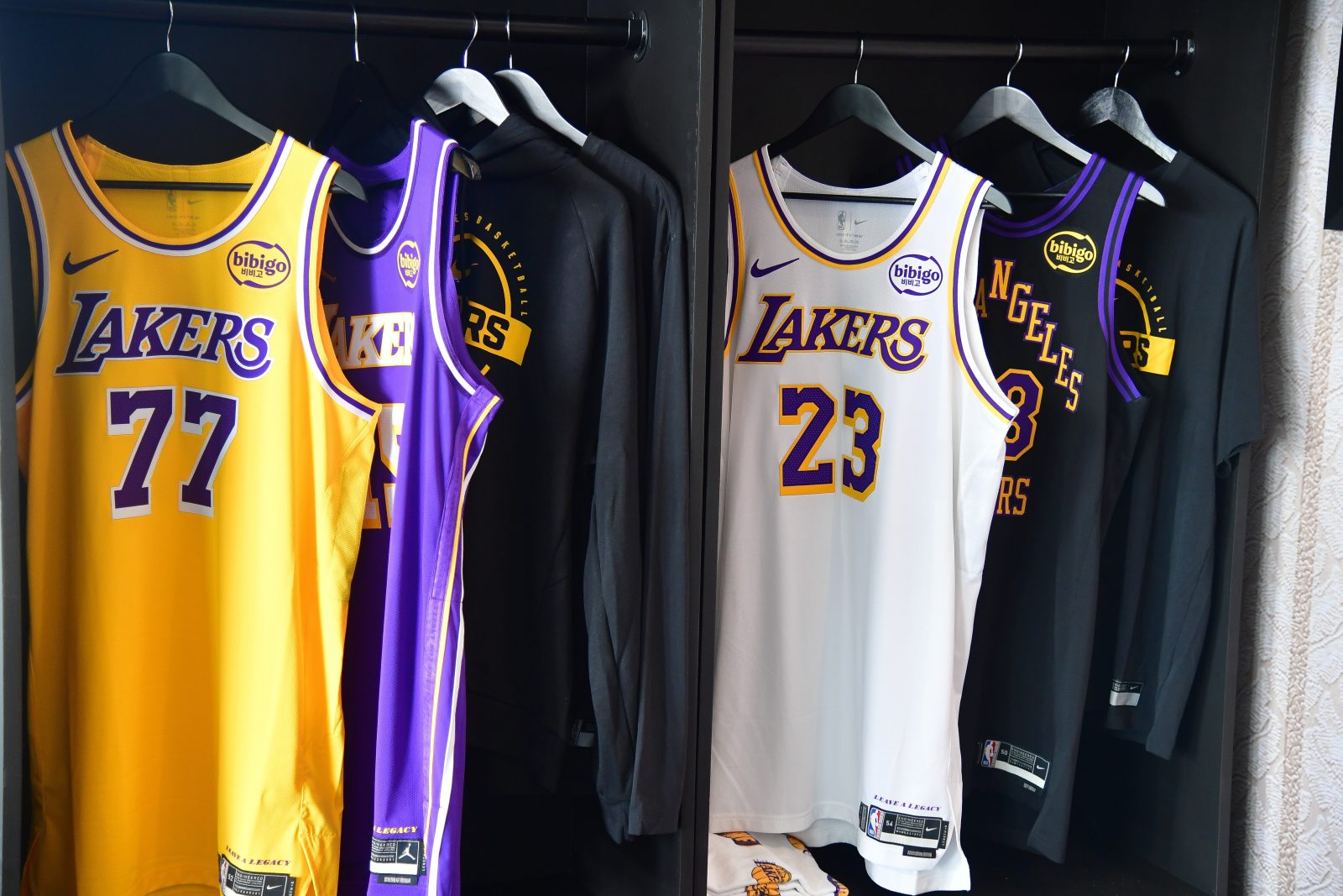 Sep 29, 2025; Los Angeles, CA, USA; Jerseys of Los Angeles Lakers guard Luka Doncic (77) and LeBron James (23) pictured during media day at UCLA Health Training Center.