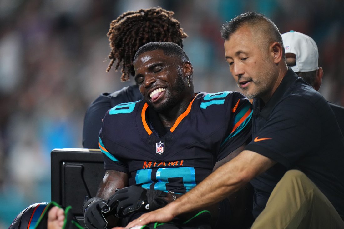 Sep 29, 2025; Miami Gardens, Florida, USA; Miami Dolphins wide receiver Tyreek Hill (10) is tended to by medical staff after injuring his leg against the New York Jets during the second half at Hard Rock Stadium.