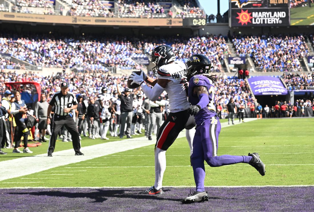 Oct 5, 2025; Baltimore, Maryland, USA; Houston Texans wide receiver Xavier Hutchinson (19) catches a touchdown pass past Baltimore Ravens cornerback T.J. Tampa (27) during the second quarter at M&T Bank Stadium. Mandatory Credit: Rafael Suanes-Imagn Images