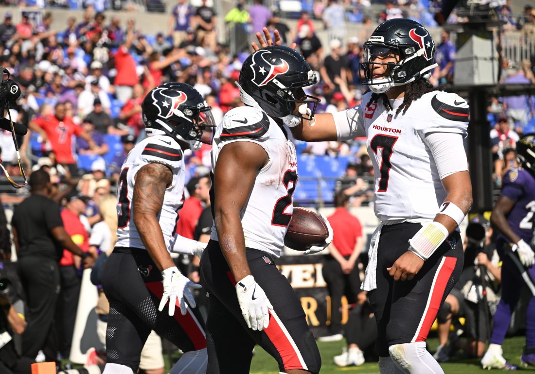 Oct 5, 2025; Baltimore, Maryland, USA; Houston Texans running back Nick Chubb (21) celebrates with quarterback C.J. Stroud (7) after scoring a touchdown during the third quarter against the Baltimore Ravens at M&T Bank Stadium.