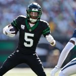Oct 5, 2025; East Rutherford, New Jersey, USA; New York Jets wide receiver Garrett Wilson (5) carries the ball after the catch against the Dallas Cowboys during the first half at MetLife Stadium. Mandatory Credit: Vincent Carchietta-Imagn Images