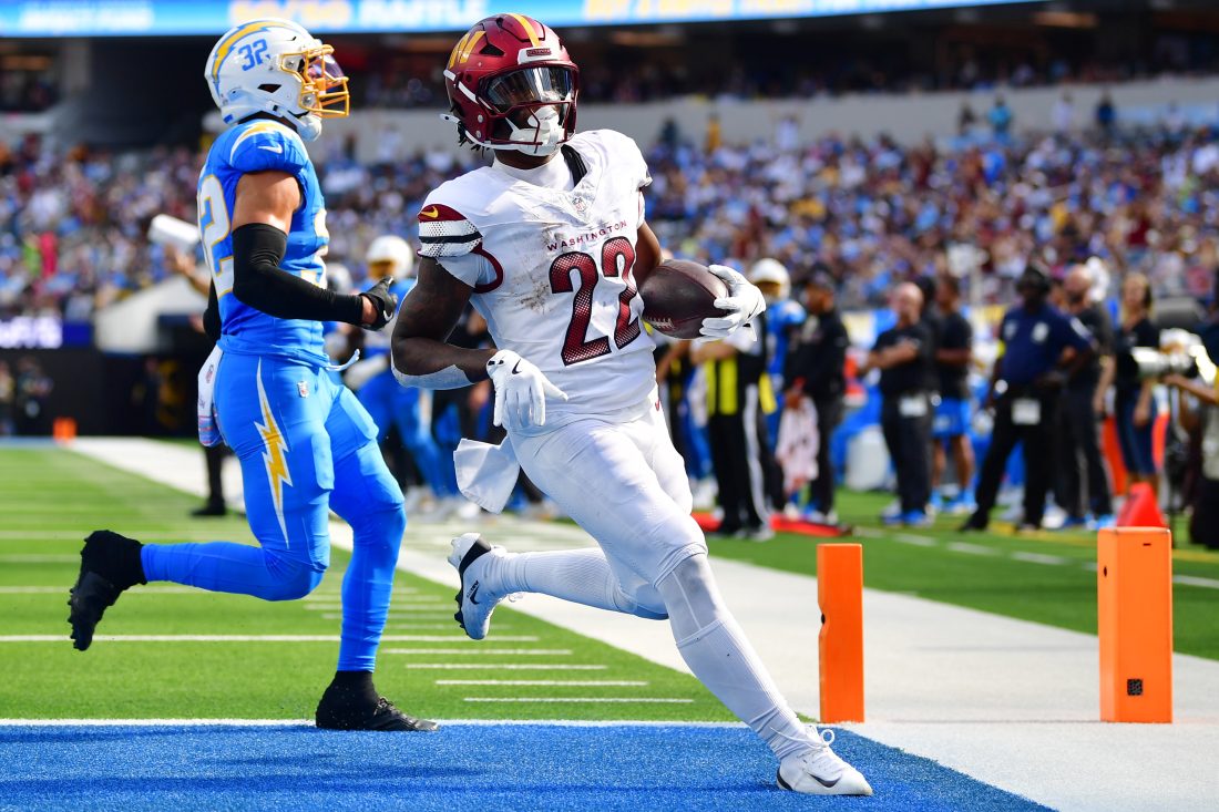 Oct 5, 2025; Inglewood, California, USA; Washington Commanders running back Jacory Croskey-Merritt (22) runs for a touchdown against the Los Angeles Chargers in the second half at SoFi Stadium. Mandatory Credit: Gary A. Vasquez-Imagn Images