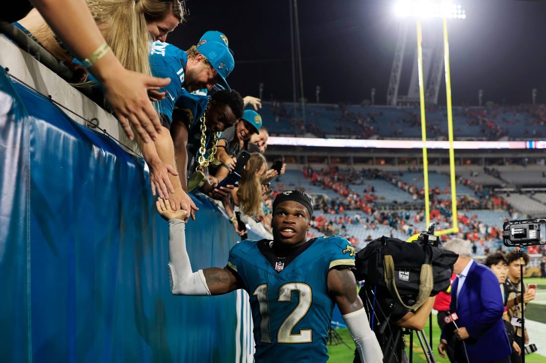 Jacksonville Jaguars wide receiver Travis Hunter (12) high-fives fans after the game of an NFL football matchup at EverBank Stadium, Monday, Oct. 6, 2025, in Jacksonville, Fla. The Jacksonville Jaguars edged the Kansas City Chiefs 31-28.