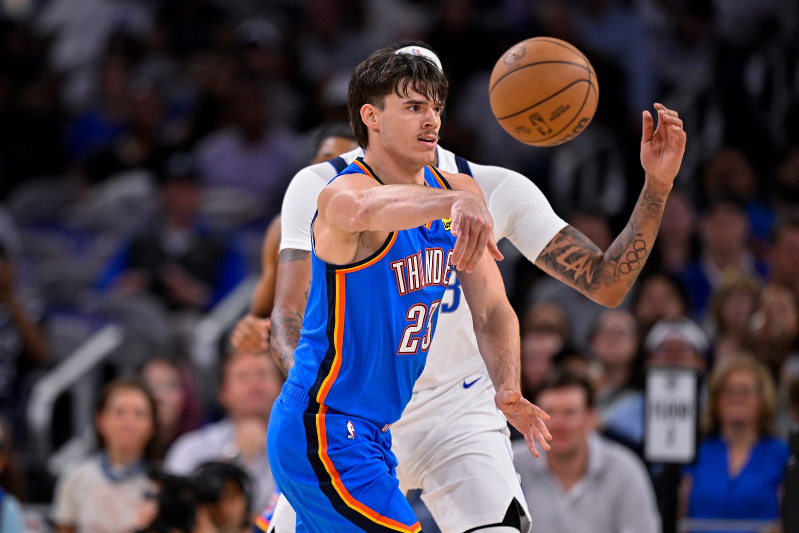 Oct 6, 2025; Fort Worth, Texas, USA; Oklahoma City Thunder guard Brooks Barnhizer (23) moves the ball past Dallas Mavericks forward/center Anthony Davis (3) during the game between the Dallas Mavericks and the Oklahoma City Thunder at Dickie's Arena. Mandatory Credit: Jerome Miron-Imagn Images