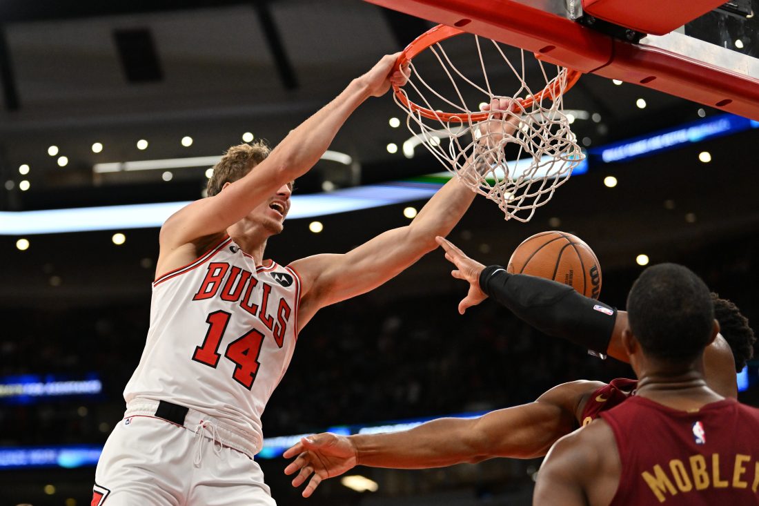 Oct 9, 2025; Chicago, Illinois, USA; Chicago Bulls forward Matas Buzelis (14) dunks against Cleveland Cavaliers guard Donovan Mitchell (45) and forward Evan Mobley (4) during the second half at United Center.