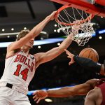 Oct 9, 2025; Chicago, Illinois, USA; Chicago Bulls forward Matas Buzelis (14) dunks against Cleveland Cavaliers guard Donovan Mitchell (45) and forward Evan Mobley (4) during the second half at United Center.