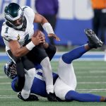 Oct 9, 2025; East Rutherford, New Jersey, USA; New York Giants linebacker Brian Burns (0) sacks Philadelphia Eagles quarterback Jalen Hurts (1) during the third quarter at MetLife Stadium. Mandatory Credit: Brad Penner-Imagn Images