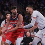Oct 13, 2025; New York, New York, USA; Washington Wizards forward Tristan Vukcevic (00) looks to pass asNew York Knicks center Alex Len (21) defends during the first half at Madison Square Garden. Mandatory Credit: Vincent Carchietta-Imagn Images