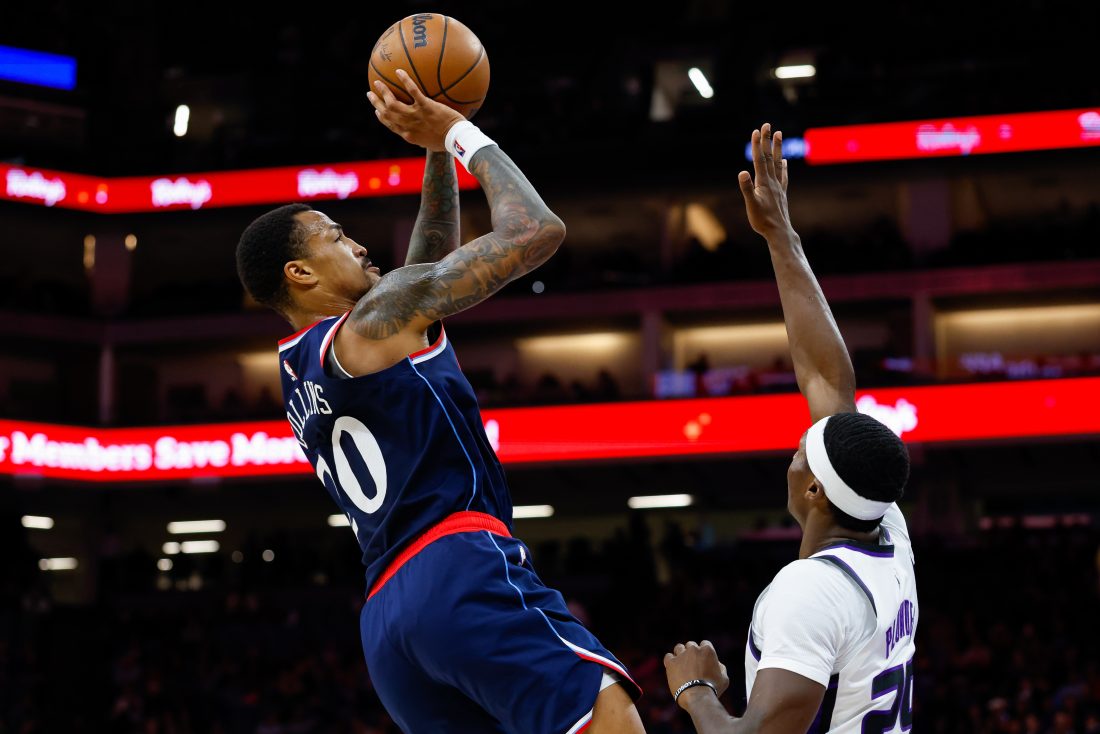 Oct 15, 2025; Sacramento, California, USA; Los Angeles Clippers forward John Collins (20) shoots the ball against Sacramento Kings guard Daeqwon Plowden (29) during the fourth quarter at Golden 1 Center. Mandatory Credit: Sergio Estrada-Imagn Images