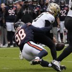 Oct 19, 2025; Chicago, Illinois, USA; New Orleans Saints quarterback Spencer Rattler (2) fumbles the ball on a sack by Chicago Bears defensive end Montez Sweat (98) during the first half at Soldier Field. Mandatory Credit: David Banks-Imagn Images