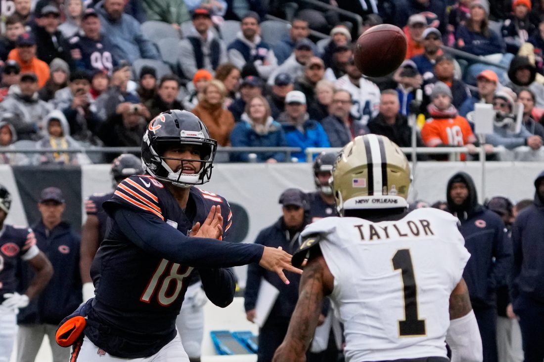 Oct 19, 2025; Chicago, Illinois, USA; Chicago Bears quarterback Caleb Williams (18) throws a pass against New Orleans Saints cornerback Alontae Taylor (1) during the first half at Soldier Field. Mandatory Credit: David Banks-Imagn Images