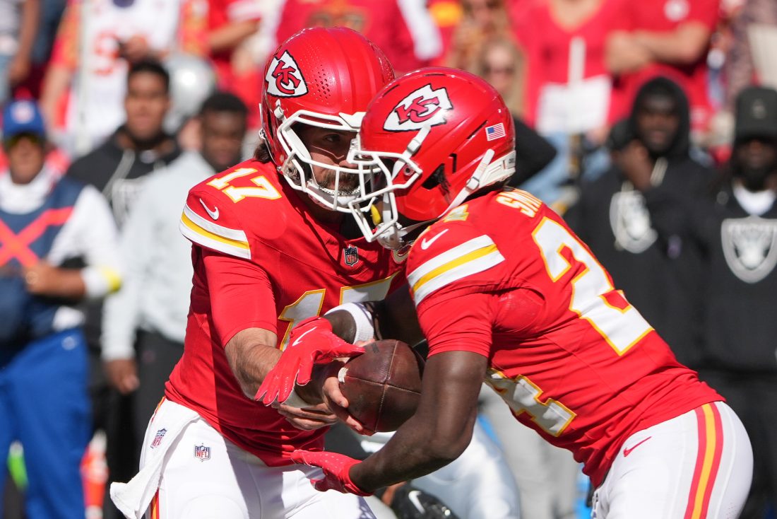 Oct 19, 2025; Kansas City, Missouri, USA; Kansas City Chiefs quarterback Gardner Minshew (17) hands teh ball to running back Brashard Smith (24) against the Las Vegas Raiders during the fourth quarter of the game at GEHA Field at Arrowhead Stadium. Mandatory Credit: Denny Medley-Imagn Images