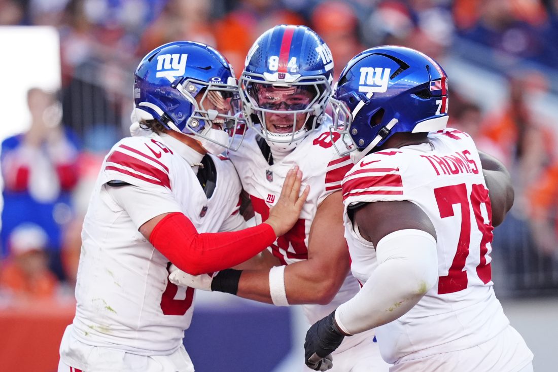 Oct 19, 2025; Denver, Colorado, USA; New York Giants quarterback Jaxson Dart (6), New York Giants tight end Theo Johnson (84) and New York Giants offensive tackle Andrew Thomas (78) react after a play during the second half against the Denver Broncos at Empower Field at Mile High.