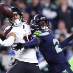 Oct 20, 2025; Seattle, Washington, USA; Seattle Seahawks cornerback Riq Woolen (27) defends a pass intended for Houston Texans wide receiver Xavier Hutchinson (19) during the fourth quarter at Lumen Field.