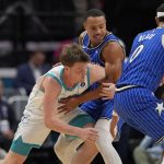 Oct 30, 2025; Charlotte, North Carolina, USA; Charlotte Hornets guard Kon Knueppel (7) and Orlando Magic guard Desmond Bane (3) fight for possession during the first quarter at Spectrum Center. Mandatory Credit: Jim Dedmon-Imagn Images