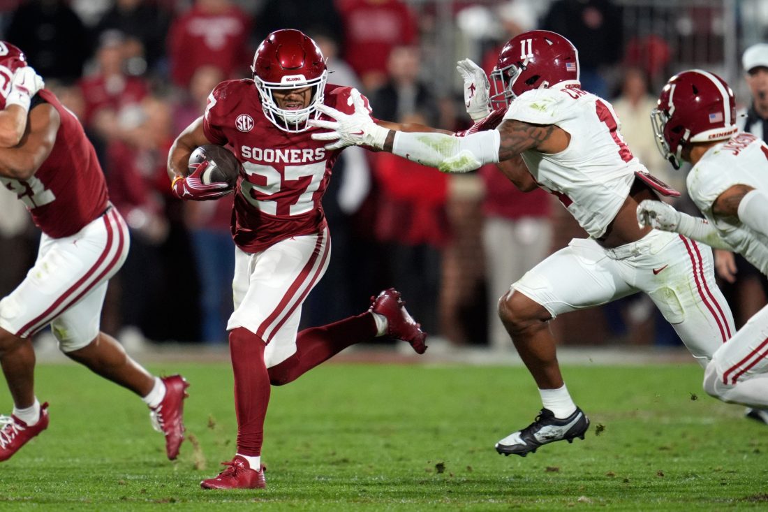 Oklahoma Sooners running back Gavin Sawchuk (27) tries to get away from Alabama Crimson Tide linebacker Jihaad Campbell (11) during a college football game between the University of Oklahoma Sooners (OU) and the Alabama Crimson Tide at Gaylord Family - Oklahoma Memorial Stadium in Norman, Okla., Saturday, Nov. 23, 2024. Oklahoma won 24-3.