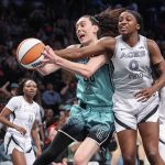 Jul 8, 2025; Brooklyn, New York, USA; New York Liberty forward Breanna Stewart (30) and Las Vegas Aces guard Jackie Young (0) fight for a loose ball in the third quarter at Barclays Center.