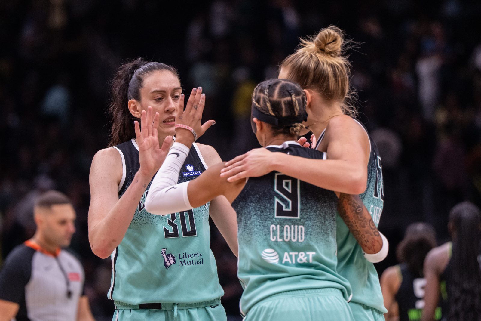 Sep 5, 2025; Seattle, Washington, USA; New York Liberty forward Breanna Stewart (30) guard Natasha Cloud (9) and forward Leonie Fiebich (13) celebrate after a game against the Seattle Storm at Climate Pledge Arena.