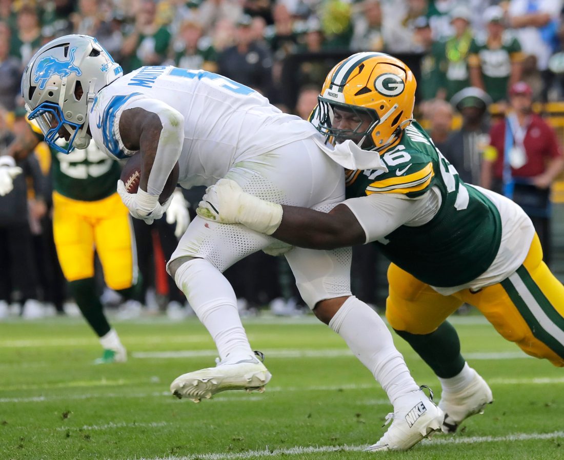 Green Bay Packers linebacker Edgerrin Cooper (56) tackles Detroit Lions running back David Montgomery (5) on Sunday, September 7, 2025, at Lambeau Field in Green Bay, Wis. The Packers defeated the Lions 27-13.