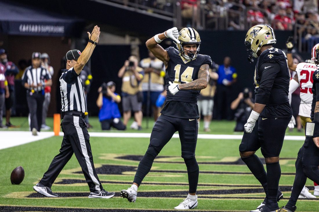 Sep 14, 2025; New Orleans, Louisiana, USA; New Orleans Saints wide receiver Devaughn Vele (14) reacts to scoring a touchdown against San Francisco 49ers safety Jason Pinnock (25) during the second half at Caesars Superdome.