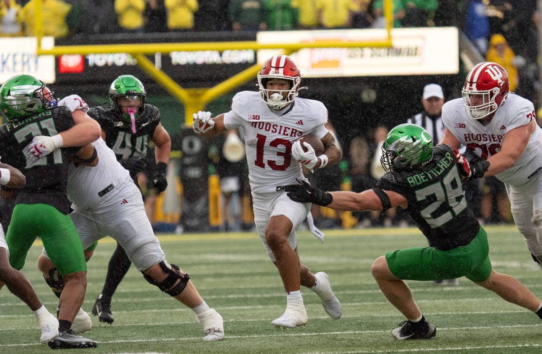 Indiana’s Elijah Sarratt, center, rushes against Oregon during the fourth quarter at Autzen Stadium October 11, 2025.