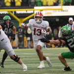 Indiana’s Elijah Sarratt, center, rushes against Oregon during the fourth quarter at Autzen Stadium October 11, 2025.