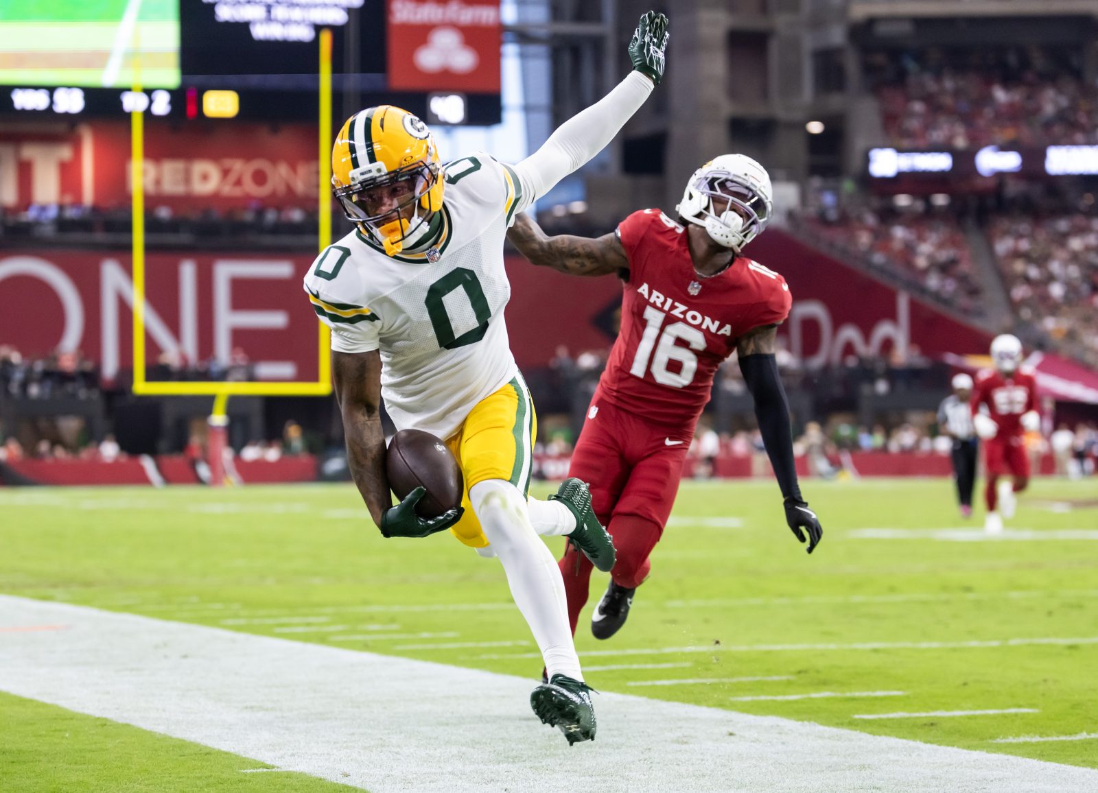 Oct 19, 2025; Glendale, Arizona, USA; Green Bay Packers wide receiver Matthew Golden (0) is pushed out of bounds by Arizona Cardinals cornerback Max Melton (16) in the second half at State Farm Stadium. Mandatory Credit: Mark J. Rebilas-Imagn Images