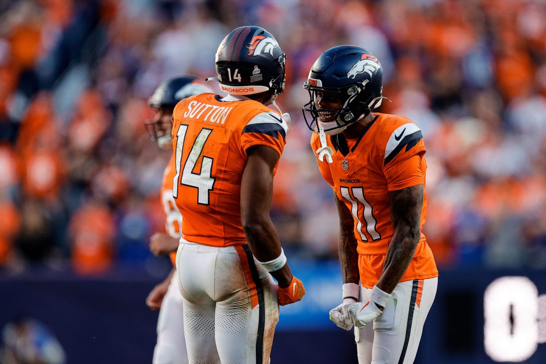Oct 19, 2025; Denver, Colorado, USA; Denver Broncos wide receiver Troy Franklin (11) reacts with wide receiver Courtland Sutton (14) after a play in the fourth quarter against the New York Giants at Empower Field at Mile High. Mandatory Credit: Isaiah J. Downing-Imagn Images