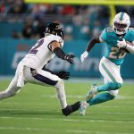 Oct 30, 2025; Miami Gardens, Florida, USA; Miami Dolphins running back De'Von Achane (28) runs for a gain past Baltimore Ravens safety Alohi Gilman (12) during the first quarter at Hard Rock Stadium. Mandatory Credit: Nathan Ray Seebeck-Imagn Images