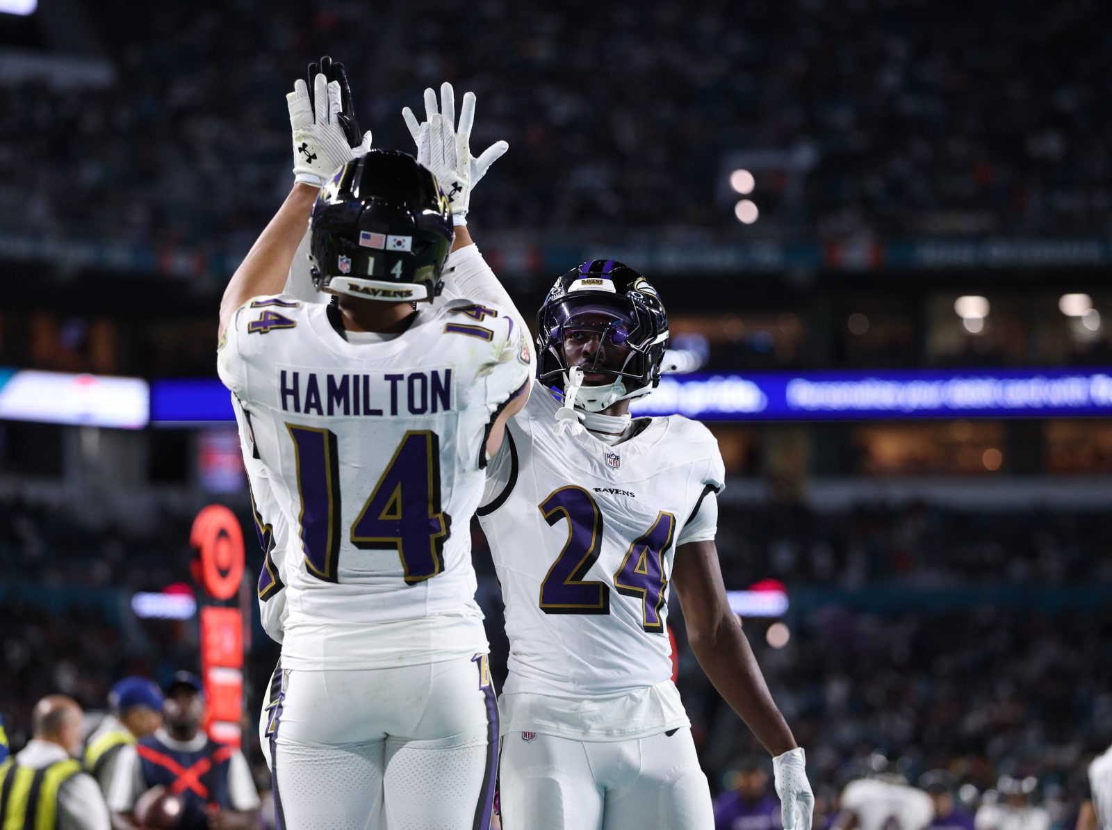 Oct 30, 2025; Miami Gardens, Florida, USA; Baltimore Ravens safety Kyle Hamilton (14) and safety Malaki Starks (24) react after a play during the second quarter against the Miami Dolphins at Hard Rock Stadium.
