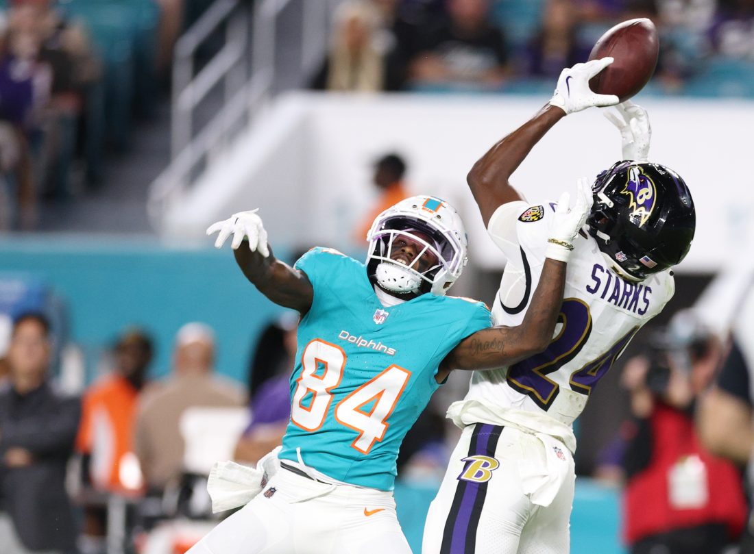 Oct 30, 2025; Miami Gardens, Florida, USA; Baltimore Ravens safety Malaki Starks (24) intercepts a pass intended for Miami Dolphins wide receiver Tahj Washington (84) during the fourth quarter at Hard Rock Stadium. Mandatory Credit: Nathan Ray Seebeck-Imagn Images