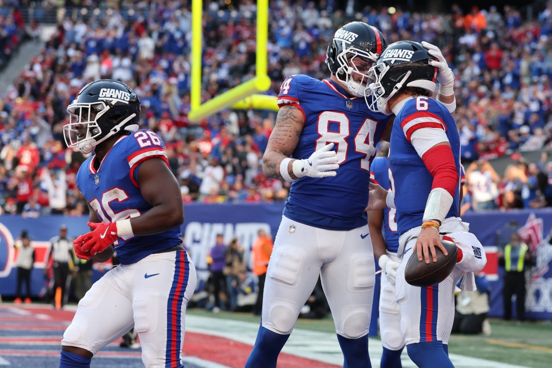 Nov 2, 2025; East Rutherford, New Jersey, USA; New York Giants quarterback Jaxson Dart (6) celebrates his touchdown run with tight end Theo Johnson (84) during the second half at MetLife Stadium. Mandatory Credit: Ed Mulholland-Imagn Images