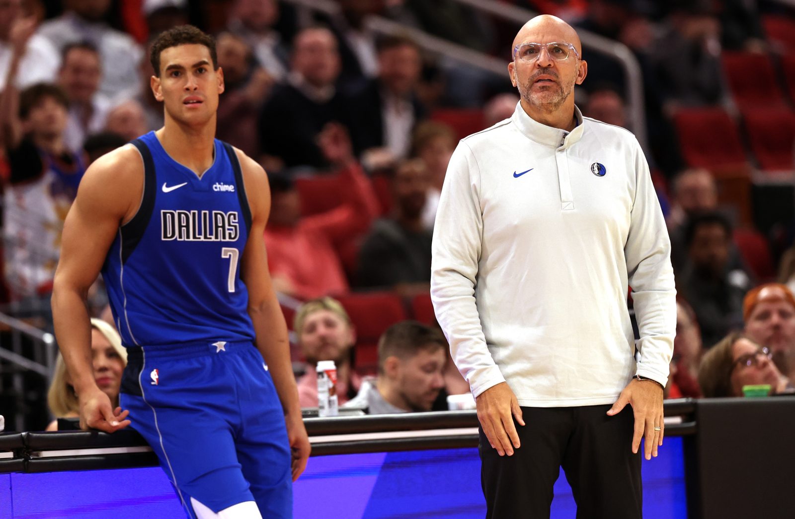 Nov 3, 2025; Houston, Texas, USA; Dallas Mavericks head coach Jason Kidd and forward Dwight Powell (7) watch play against the Houston Rockets the second quarter at Toyota Center.