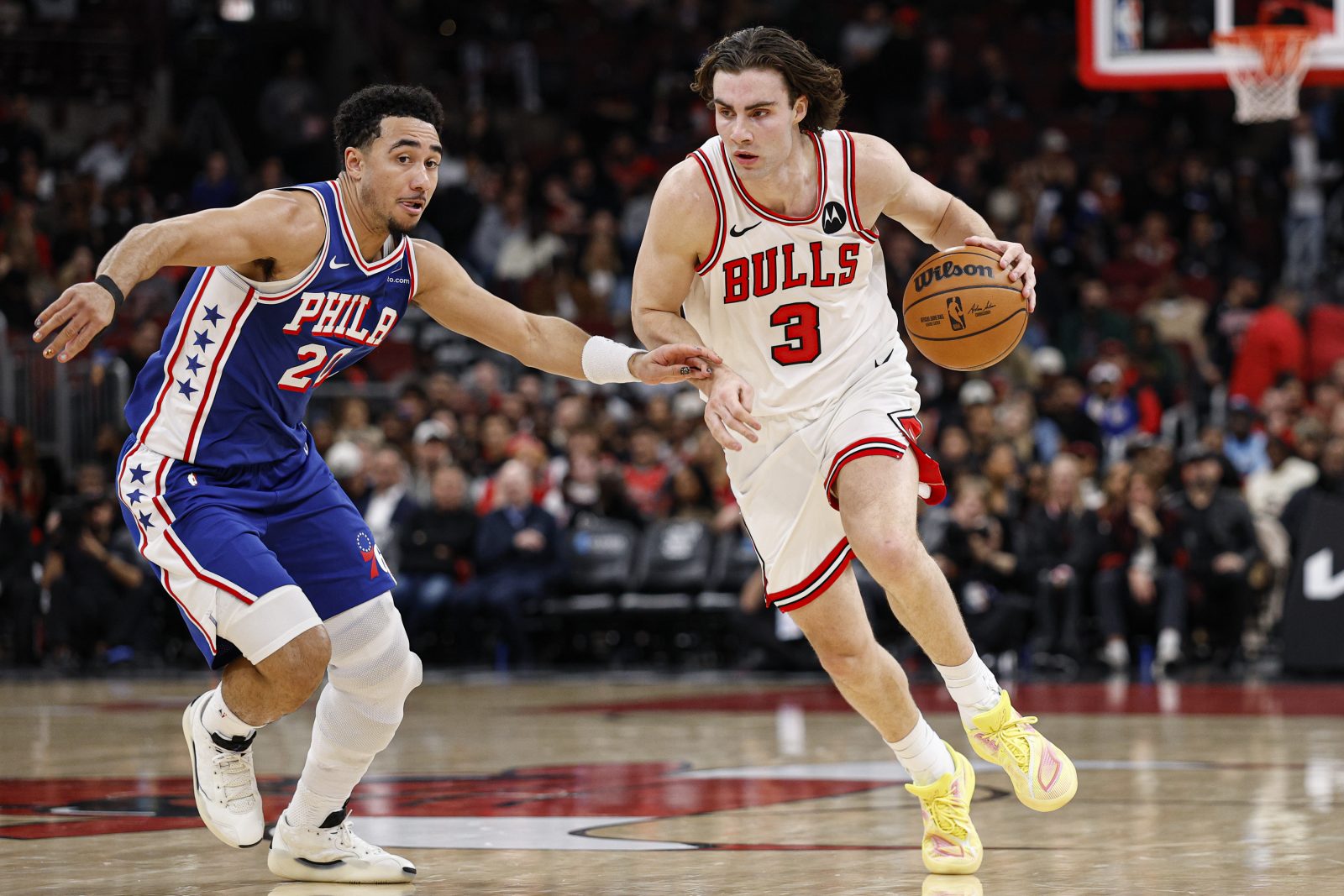 Nov 4, 2025; Chicago, Illinois, USA; Chicago Bulls guard Josh Giddey (3) drives to the basket against Philadelphia 76ers guard Jared McCain (20) during the first half at United Center.