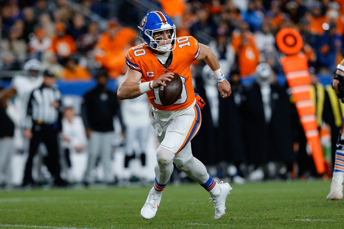 Nov 6, 2025; Denver, Colorado, USA; Denver Broncos quarterback Bo Nix (10) scrambles with the ball in the fourth quarter at Empower Field at Mile High.