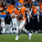 Nov 6, 2025; Denver, Colorado, USA; Denver Broncos quarterback Bo Nix (10) scrambles with the ball in the fourth quarter at Empower Field at Mile High.