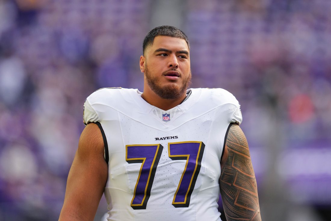 Nov 9, 2025; Minneapolis, Minnesota, USA; Baltimore Ravens guard Daniel Faalele (77) warms up before the game against the Minnesota Vikings at U.S. Bank Stadium.