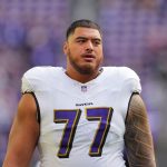Nov 9, 2025; Minneapolis, Minnesota, USA; Baltimore Ravens guard Daniel Faalele (77) warms up before the game against the Minnesota Vikings at U.S. Bank Stadium.