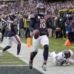 Nov 9, 2025; Chicago, Illinois, USA; Chicago Bears quarterback Caleb Williams (18) scores the game-winning touchdown against New York Giants linebacker Brian Burns (0) during the fourth quarter at Soldier Field. Mandatory Credit: David Banks-Imagn Images