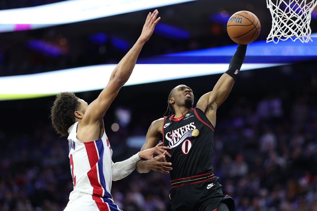 Nov 9, 2025; Philadelphia, Pennsylvania, USA; Philadelphia 76ers guard Tyrese Maxey (0) drives for dunk against Detroit Pistons guard Cade Cunningham (2) during the fourth quarter at Xfinity Mobile Arena. Mandatory Credit: Bill Streicher-Imagn Images