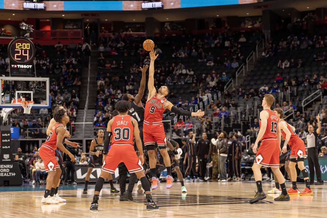 Nov 12, 2025; Detroit, Michigan, USA; Detroit Pistons forward Paul Reed (7) starts the game with a jump ball against Chicago Bulls center Nikola Vucevic (9) during the first quarter at Little Caesars Arena.
