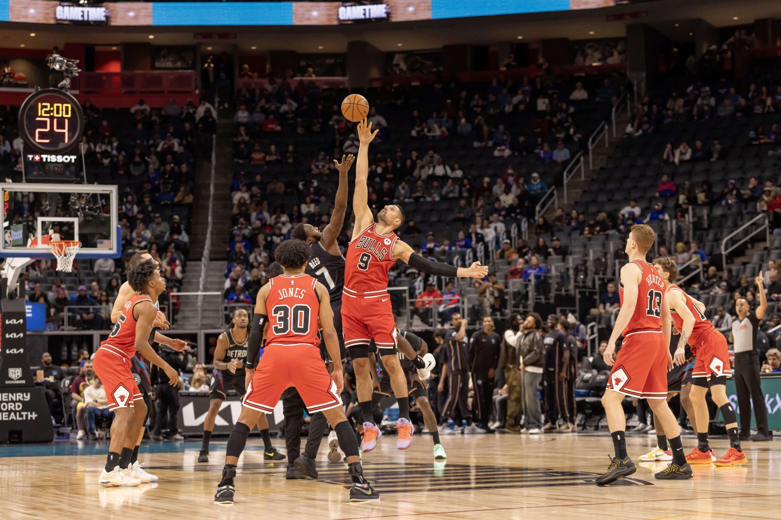 Nov 12, 2025; Detroit, Michigan, USA; Detroit Pistons forward Paul Reed (7) starts the game with a jump ball against Chicago Bulls center Nikola Vucevic (9) during the first quarter at Little Caesars Arena.
