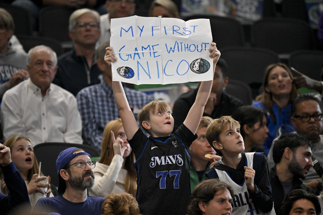 Nov 12, 2025; Dallas, Texas, USA; A young Dallas Mavericks fan in a Mavs Luka Doncic t-shirt holds up a sign referring to former general manager Nico Harrison during the game between the Dallas Mavericks and the Phoenix Suns at the American Airlines Center.
