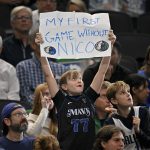 Nov 12, 2025; Dallas, Texas, USA; A young Dallas Mavericks fan in a Mavs Luka Doncic t-shirt holds up a sign referring to former general manager Nico Harrison during the game between the Dallas Mavericks and the Phoenix Suns at the American Airlines Center.