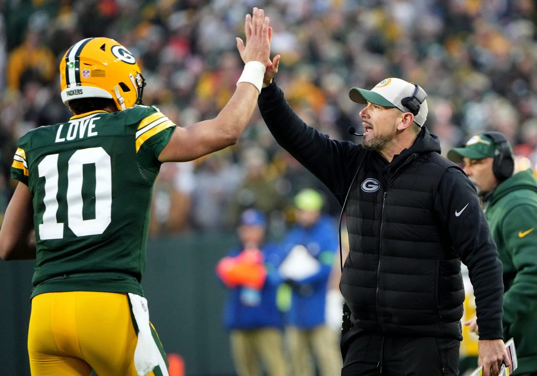 Green Bay Packers quarterback Jordan Love (10) high fives head coach Matt LaFleur after throwing a touchdown pass during the second quarter of their game against the Chicago Bear Sunday, January 7, 2024 at Lambeau Field in Green Bay,