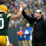 Green Bay Packers quarterback Jordan Love (10) high fives head coach Matt LaFleur after throwing a touchdown pass during the second quarter of their game against the Chicago Bear Sunday, January 7, 2024 at Lambeau Field in Green Bay,
