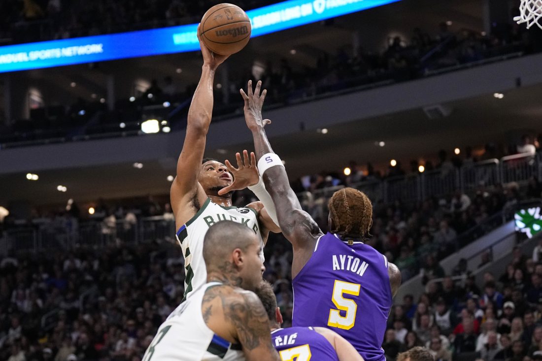 Nov 15, 2025; Milwaukee, Wisconsin, USA; Milwaukee Bucks forward Giannis Antetokounmpo (34) shoots against Los Angeles Lakers center Deandre Ayton (5) during the first quarter at Fiserv Forum.