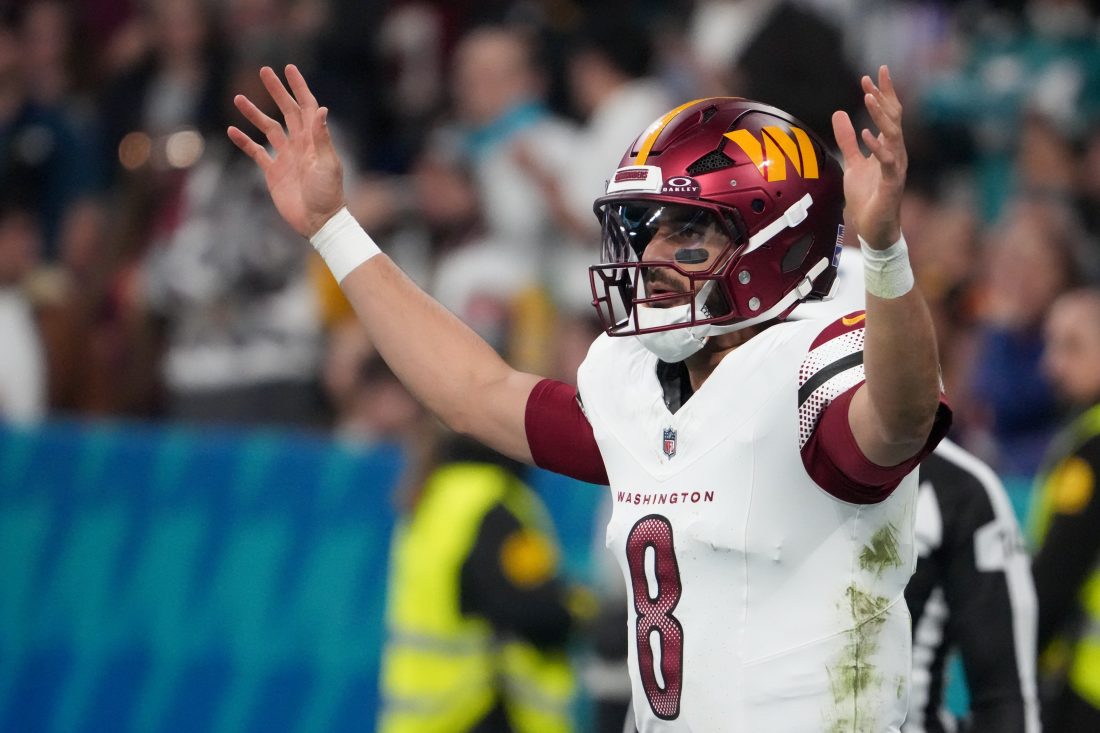 Nov 16, 2025; Madrid, Spain; Washington Commanders quarterback Marcus Mariota (8) reacts after a play against the Miami Dolphins in the third quarter during the 2025 NFL Madrid Game at Santiago Bernabeu Stadium.